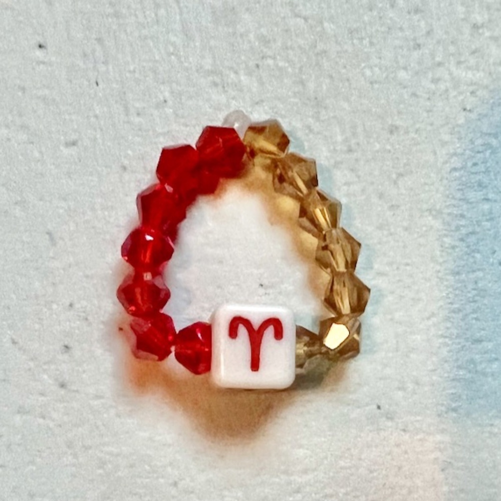“ARIES” ZODIAC CRYSTAL BEADED RING, ONE SIZE, RED/ TAN